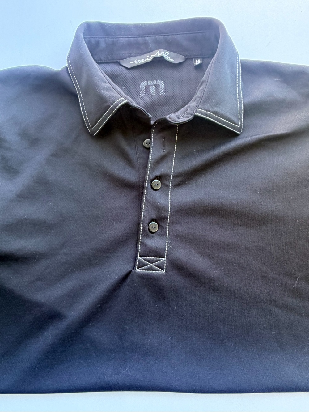 Travis Mathew Black Polo with White Contrast Stitching